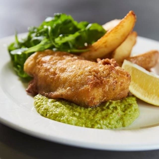 Spiced fish and chips with yoghurt pea puree